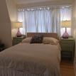 bedroom queen size bed with access to deck